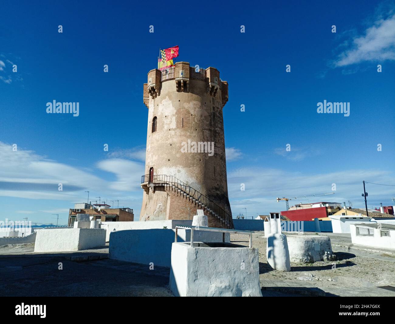 Defensive tower of Paterna and the cave houses. Paterna - Spain Stock Photo