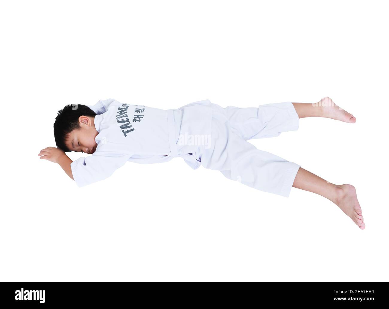 Accidents in sports. Full body of asian child athletes taekwondo with white belt lying in  prone position unconscious, isolated on white background. C Stock Photo