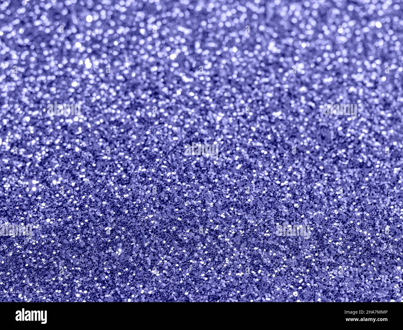 Sparkling background made of purple 2022 color. Color 2022 very peri blurred glitter backdrop for holidays and parties. Demonstrating color of 2022 year very peri Stock Photo