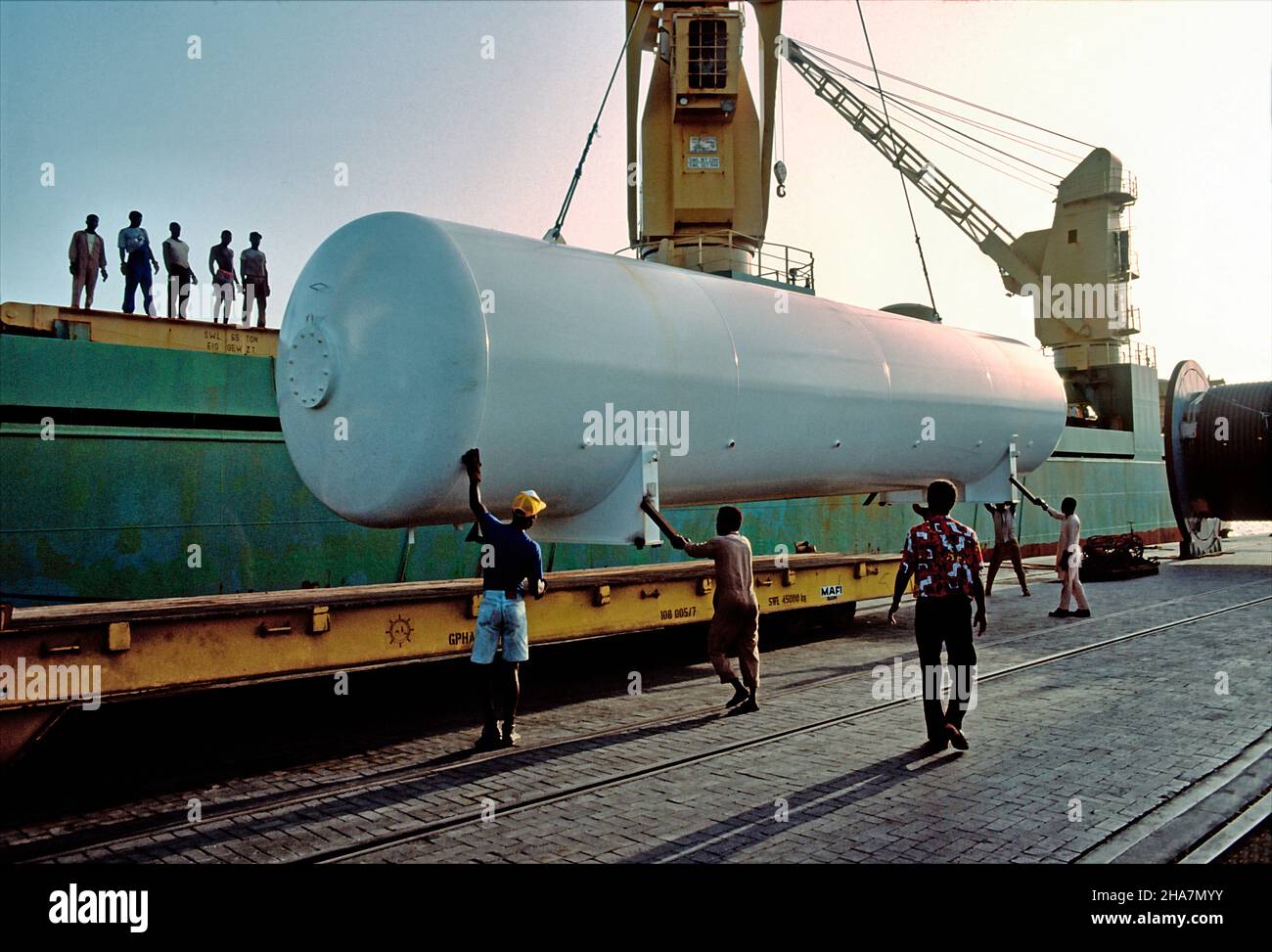 Heavy cargo, a drilling equipment, being transshipped on a mafi trailer in the Port of Tema, Ghana. Stock Photo