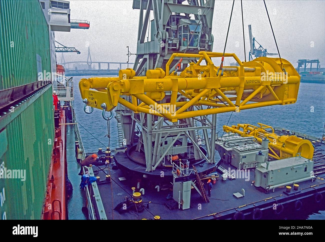 Heavy lift. Drilling rig component being loaded ontoa container vessel by a floating crane in the Port of Hambug, Germany. Stock Photo