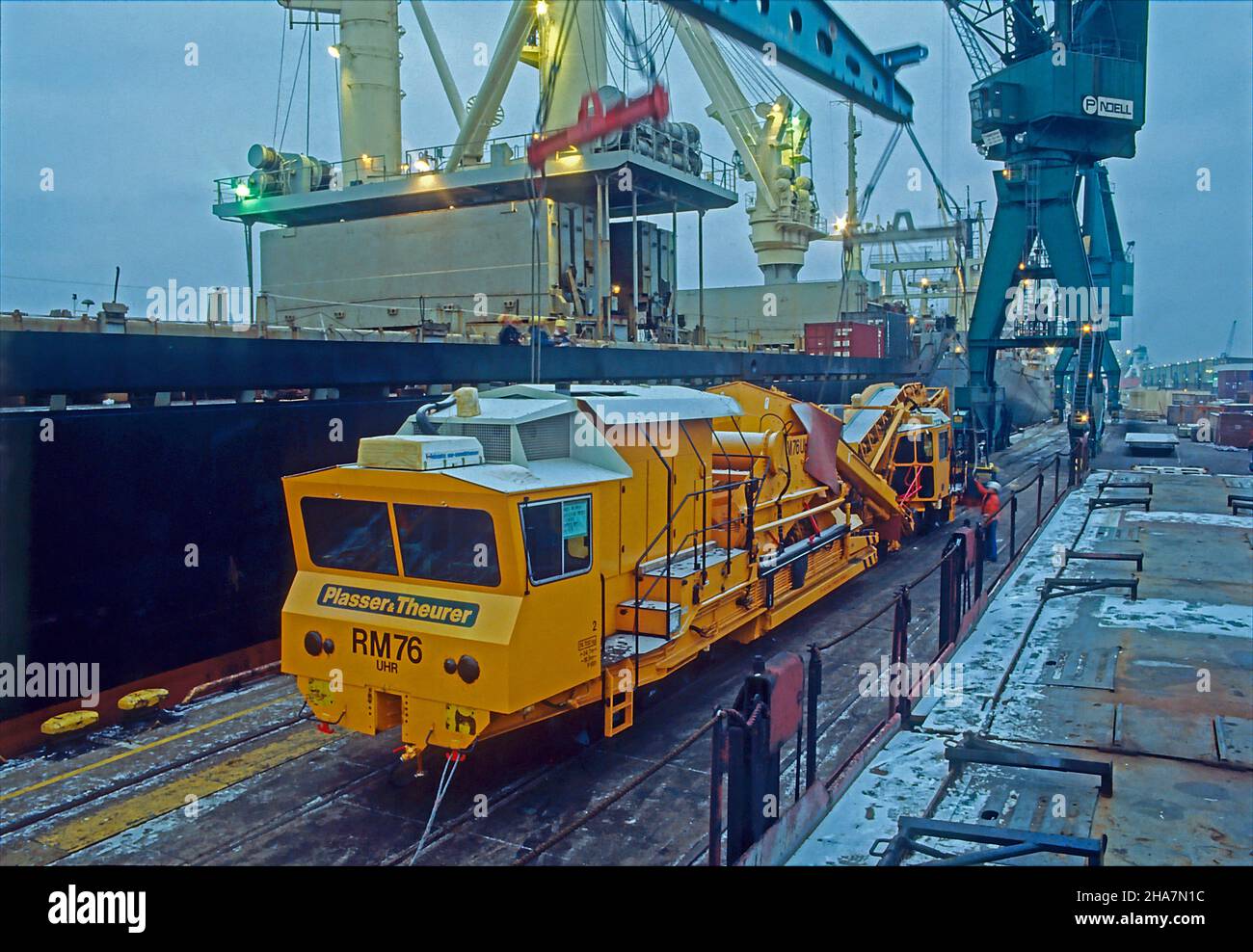 Heavy cargo, a track laying machinery ready for lift-on to a multipürpose vessel in the port of Hamburg, Germany. Stock Photo