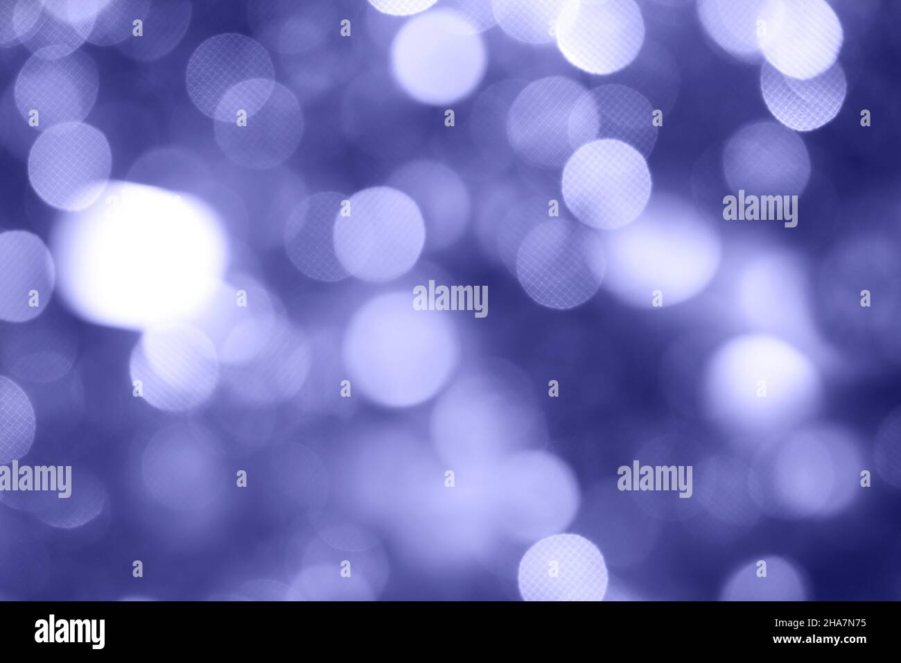 Silver and white holiday bokeh. Abstract Christmas background. Color of 2022 year, very peri, toned Stock Photo