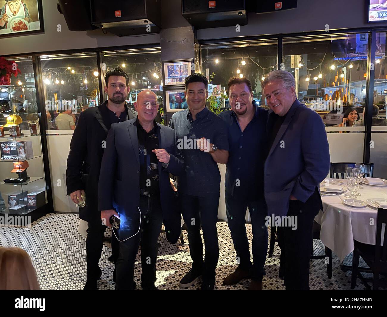 FORT LAUDERDALE; FL - DECEMBER 10: Saved by the Bell Actor, Host of Access Hollywood and the 2020 Miss Universe contest Mario Lopez Along with world champion Boxer Paulie Malignaggi, Gravesend Director and Actor William DeMeo join cook, actor and Owner Steve Martorano The 'Godfather of Italian-American cooking' December 10, 2021 At Cafe Martorano in Fort Lauderdale, Florida People: Mario Lopez . Credit: hoo-me.com/MediaPunch Stock Photo