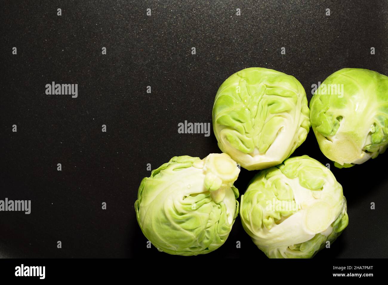 Brussels sprouts in a black nonstick pan. Focus stacked images. Stock Photo