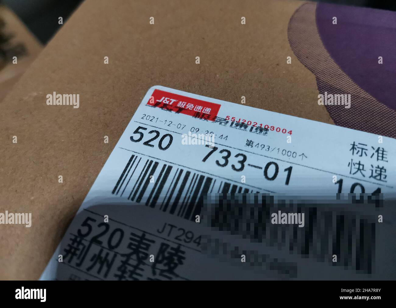 YICHANG, CHINA - DECEMBER 11, 2021 - A package is delivered by JT Express in Yichang, Hubei Province, China, Dec 11, 2021. Best Group agreed to transf Stock Photo