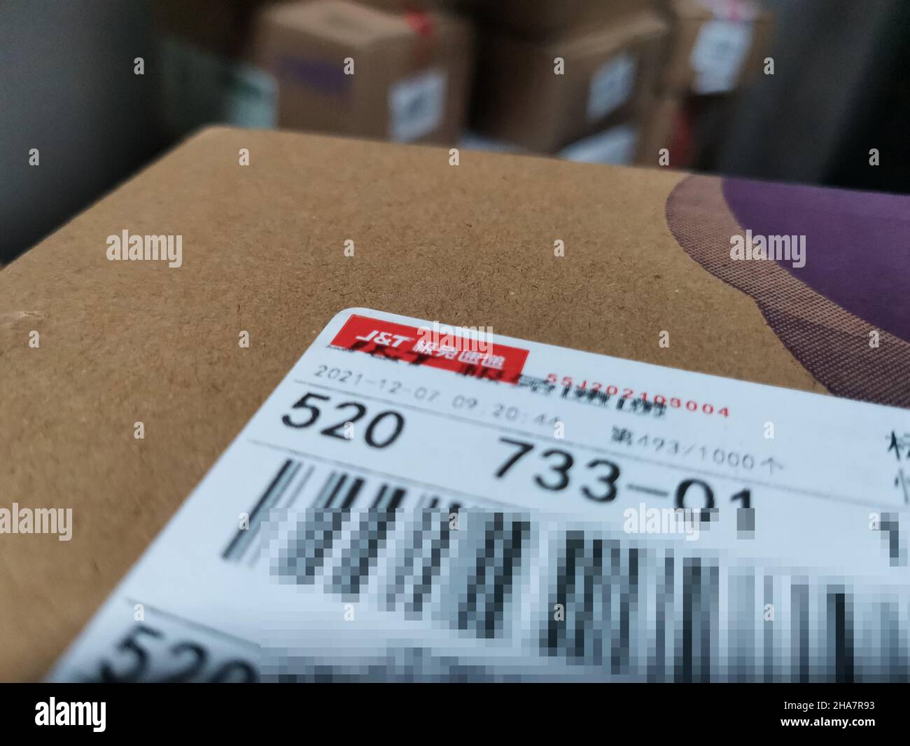 YICHANG, CHINA - DECEMBER 11, 2021 - A package is delivered by JT Express in Yichang, Hubei Province, China, Dec 11, 2021. Best Group agreed to transf Stock Photo