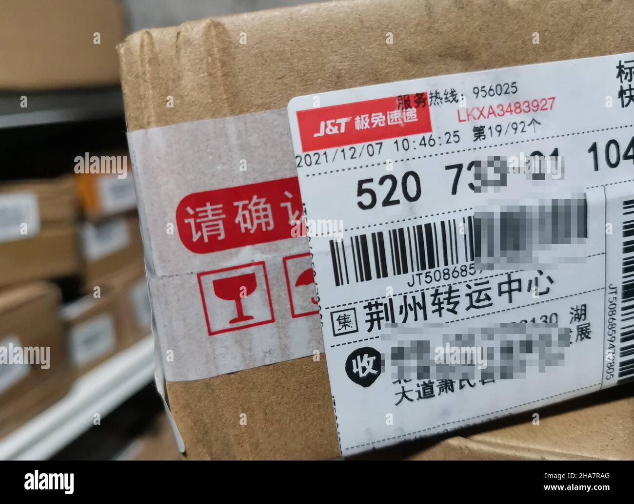 YICHANG, CHINA - DECEMBER 11, 2021 - A package is delivered by JT Express in Yichang, Hubei Province, China, Dec 11, 2021. Best Group agreed to transf Stock Photo