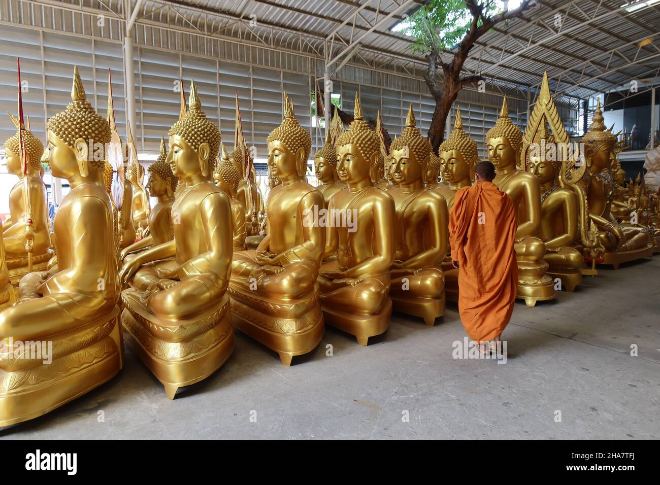 Monk with buddhist statues hi-res stock photography and images - Alamy