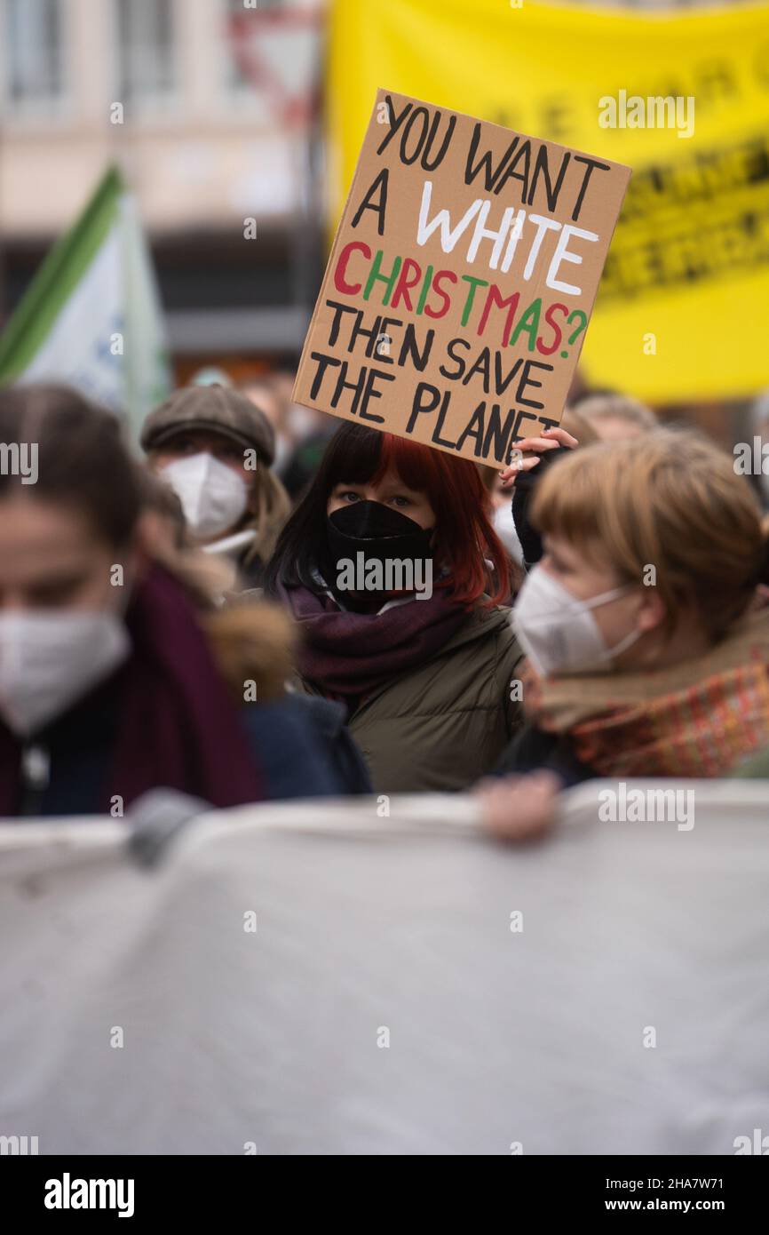 Participant with sign 'You want a white Christmas? Then save the planet'On December 10, 2021, a climate strike organized by FridaysForFuture took place in Munich, as it does every Friday, with over 150 participants loudly demonstrating for compliance with the 1.5 degree target. The demonstrators also demonstrated that Munich should be climate neutral by 2035. (Photo by Alexander Pohl/Sipa USA) Credit: Sipa USA/Alamy Live News Stock Photo
