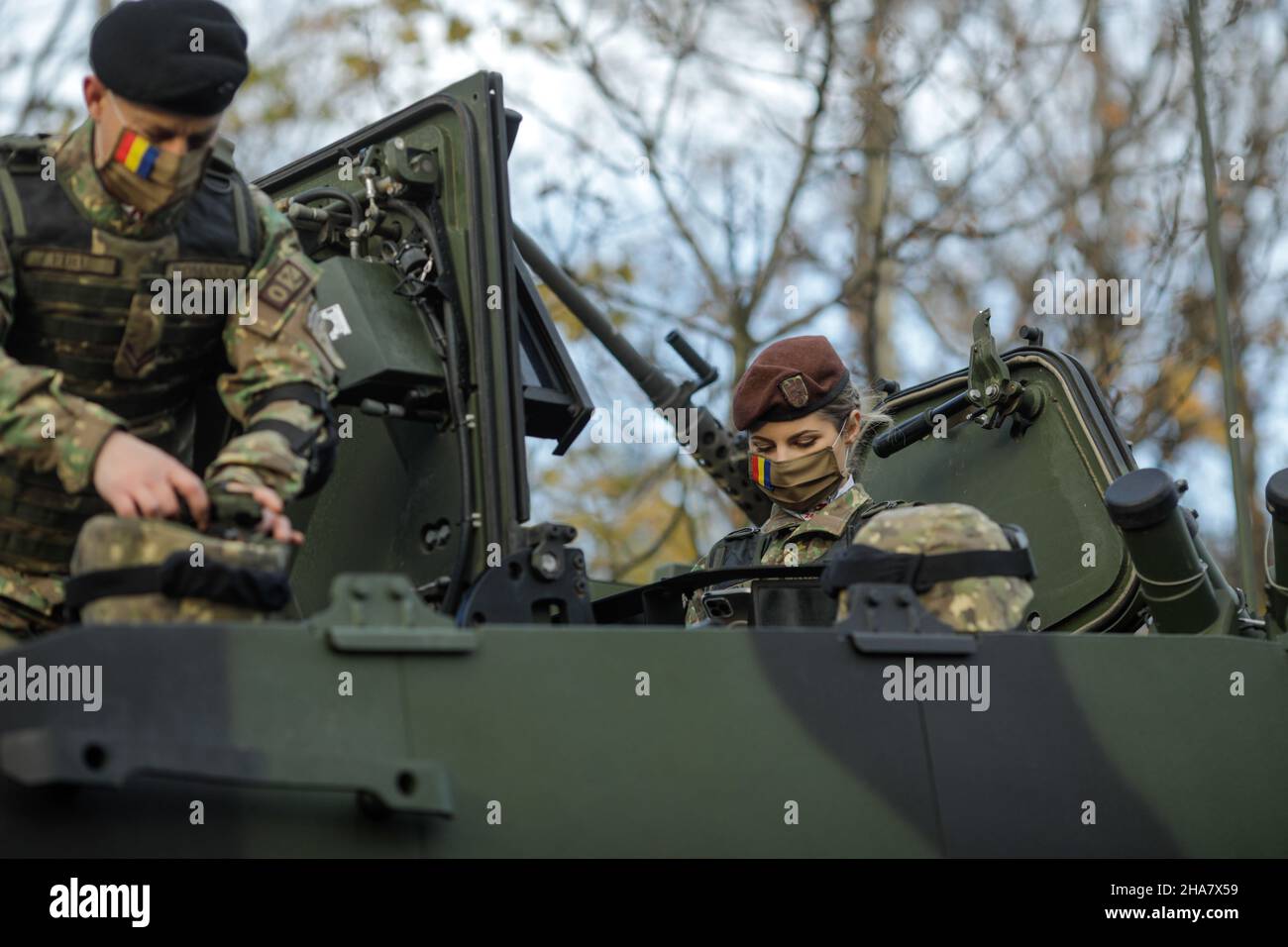 Bucharest, Romania - 1 December, 2021: Romanian army soldiers on Piranha V armored vehicles prepare for the Romanian national day military parade. Stock Photo