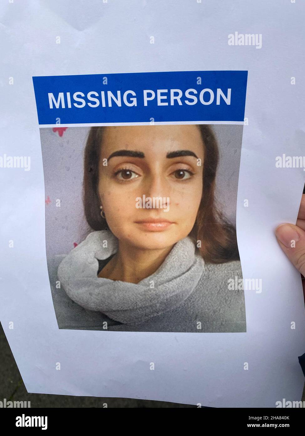 A person holds a missing poster of Petra Srncova, 32, who has been missing from south London for a week. She was last seen on a bus home after withdrawing money from a cashpoint, police have said. Picture date: Saturday December 11, 2021. Stock Photo