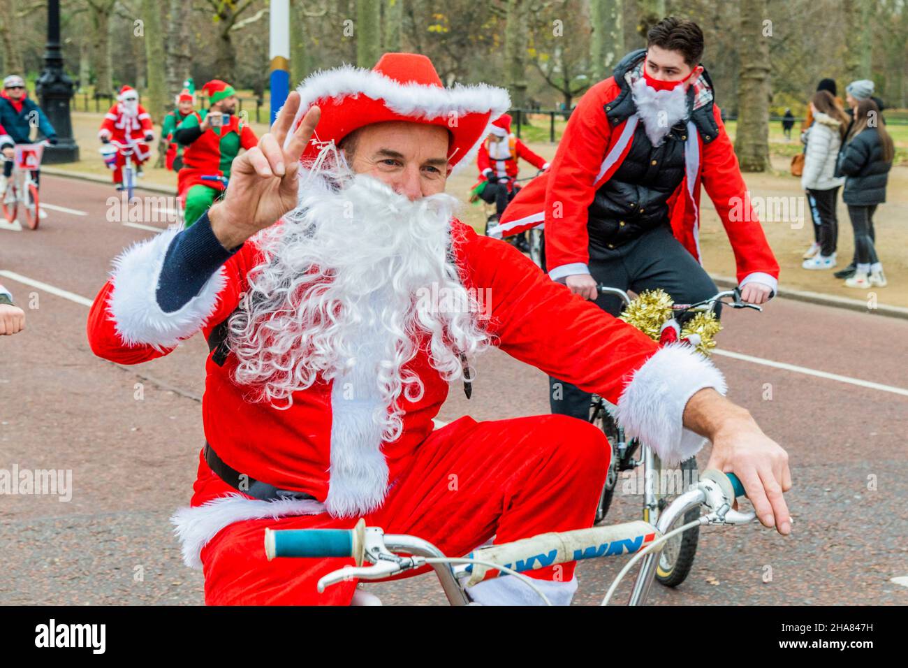 London, UK. 11th Dec, 2021. Riding down the Mall in Sant suits - The BMX Life Santa Cruise bike ride in support of the ECHO (Evelina Childrens Heart Organisation) children's heart charity. Credit: Guy Bell/Alamy Live News Stock Photo