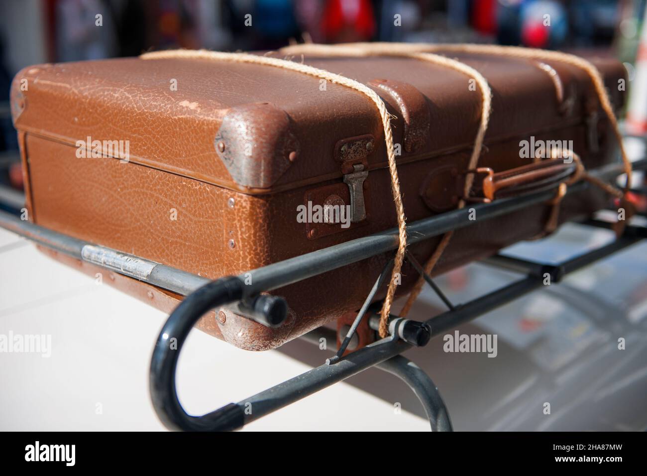 Close up of an old brown suitcase tied with ropes on a roof rack Stock Photo Alamy