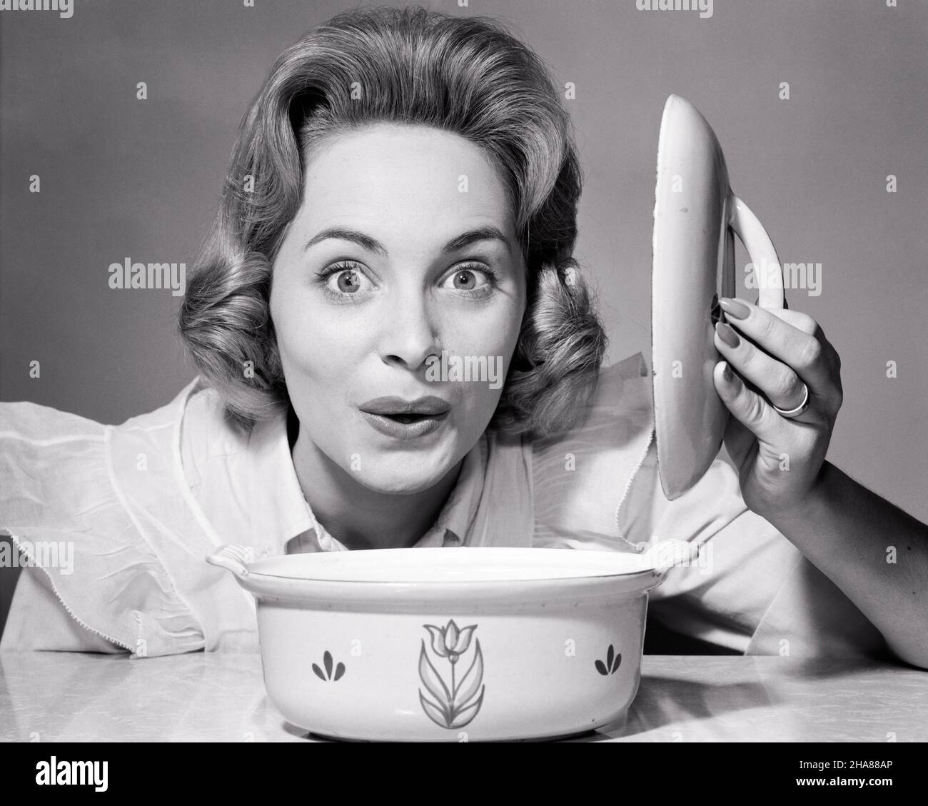 1960s 1950s SURPRISED HAPPY WOMAN HOUSEWIFE COOK LIFTING THE LID OFF OF CASSEROLE DISH LOOKING AT CAMERA - h3048 DEB001 HARS CASSEROLE FEMALES STUDIO SHOT HOME LIFE COPY SPACE LADIES PERSONS EXPRESSIONS B&W WIDE EYE CONTACT HOMEMAKER BUG-EYED HAPPINESS HOMEMAKERS HEAD AND SHOULDERS CHEERFUL EXCITEMENT PREPARATION HOUSEWIVES SMILES JOYFUL LID DEB001 WIDE-EYED MID-ADULT MID-ADULT WOMAN STARTLED BLACK AND WHITE CAUCASIAN ETHNICITY FOOD PREPARATION OLD FASHIONED Stock Photo