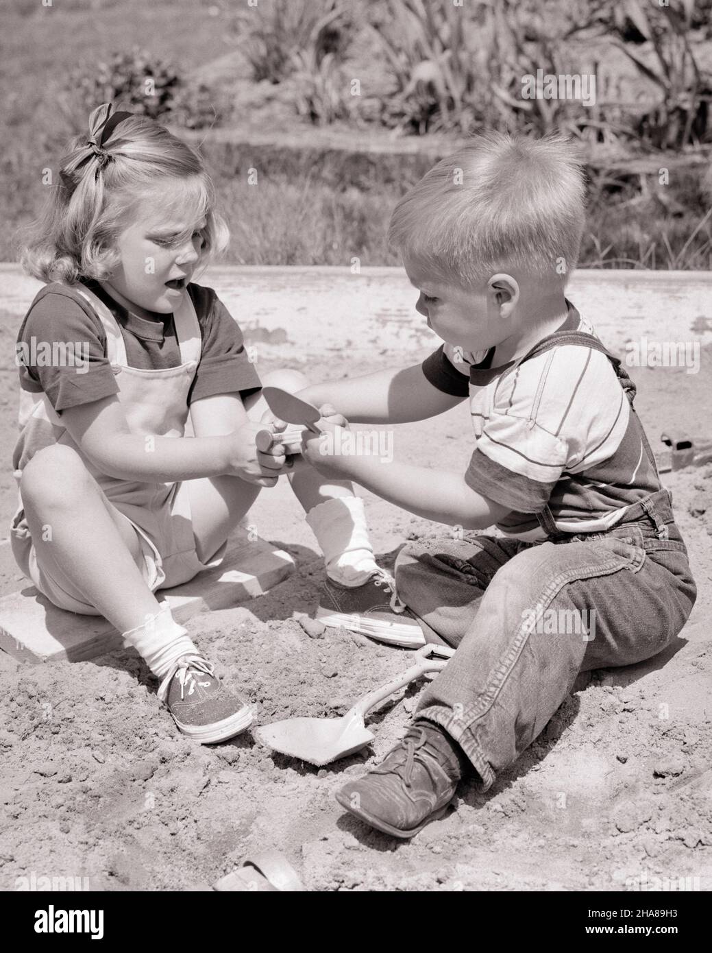 Children arguing over toy hi-res stock photography and images - Alamy