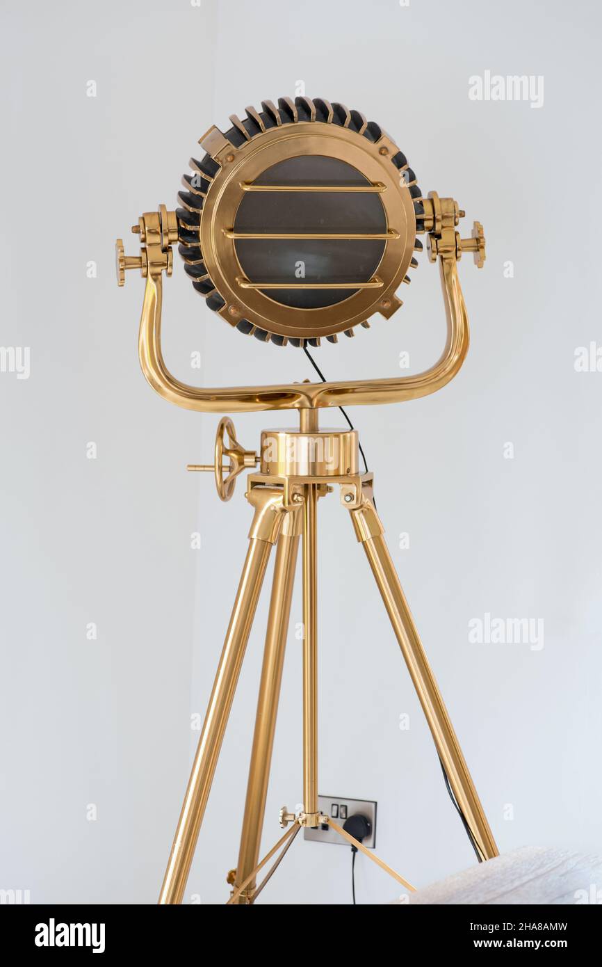A nautical, modern, studio, floor lamp as a tripod floor lamp and with  searchlight/spot lamp Stock Photo - Alamy