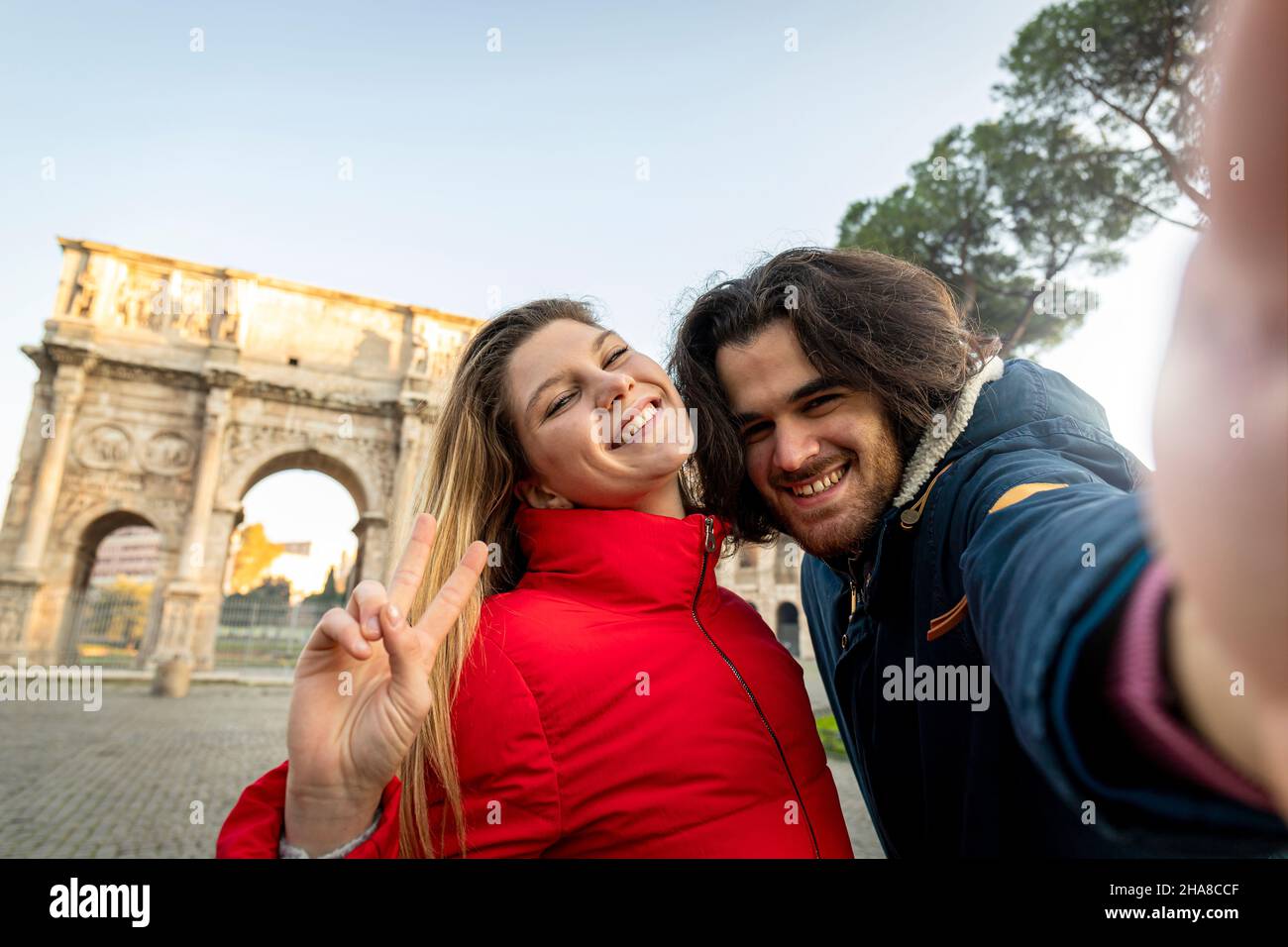 Say cheese! Young charming couple making a selfie in the historical center of Rome, near the Arch of Titus. Stock Photo