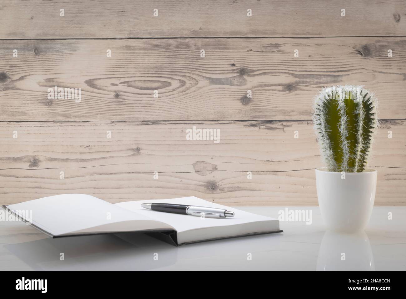 Book opened on a workspace. White pages for inscriptions. Stock Photo