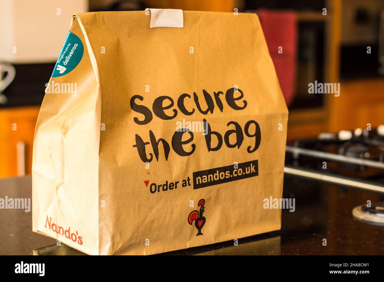 Nandos peri peri chicken take away packed in cardboard box for environment friendly responsible packaging. Stock Photo