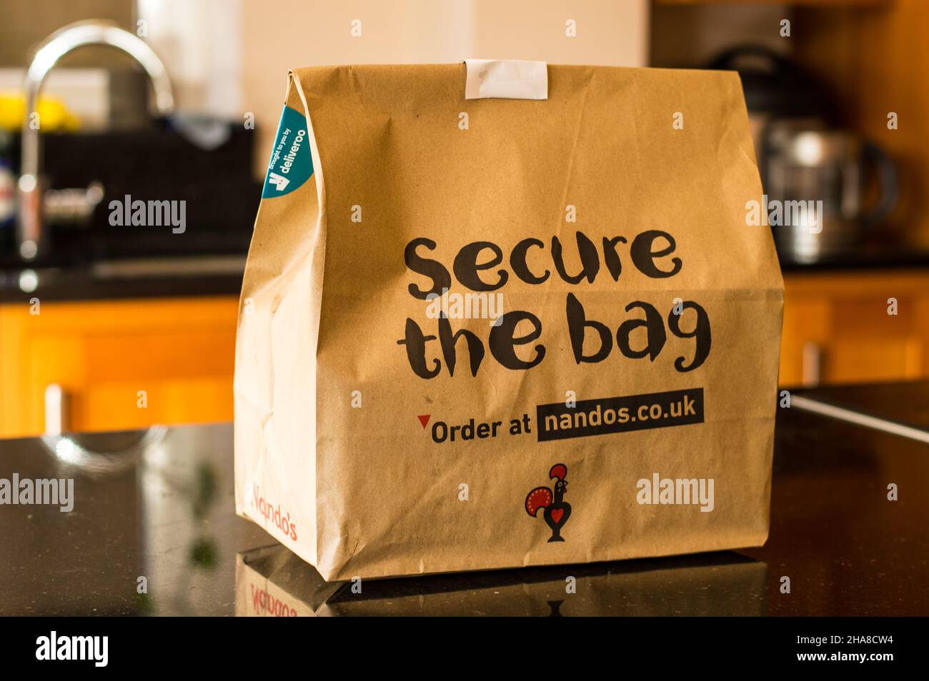 Nandos peri peri chicken take away packed in cardboard box for environment friendly responsible packaging. Stock Photo