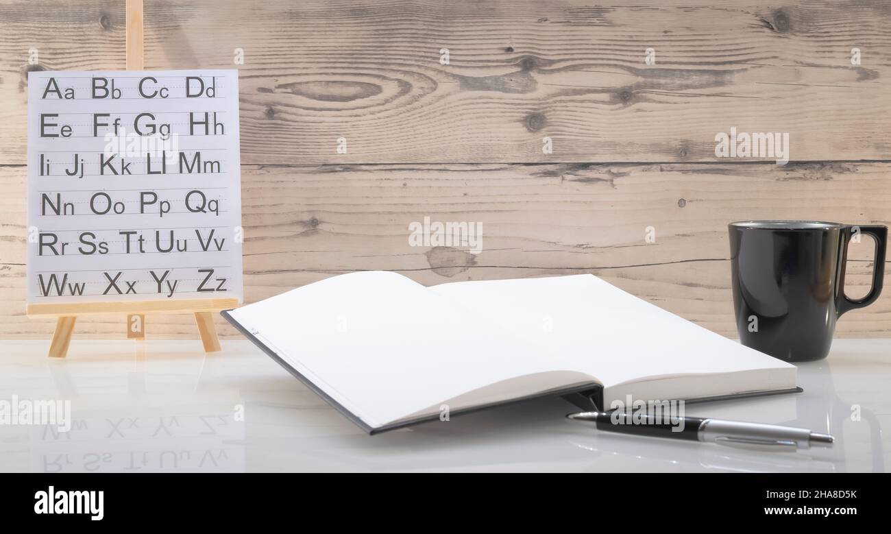 Book opened on a workspace. White pages for inscriptions. Stock Photo