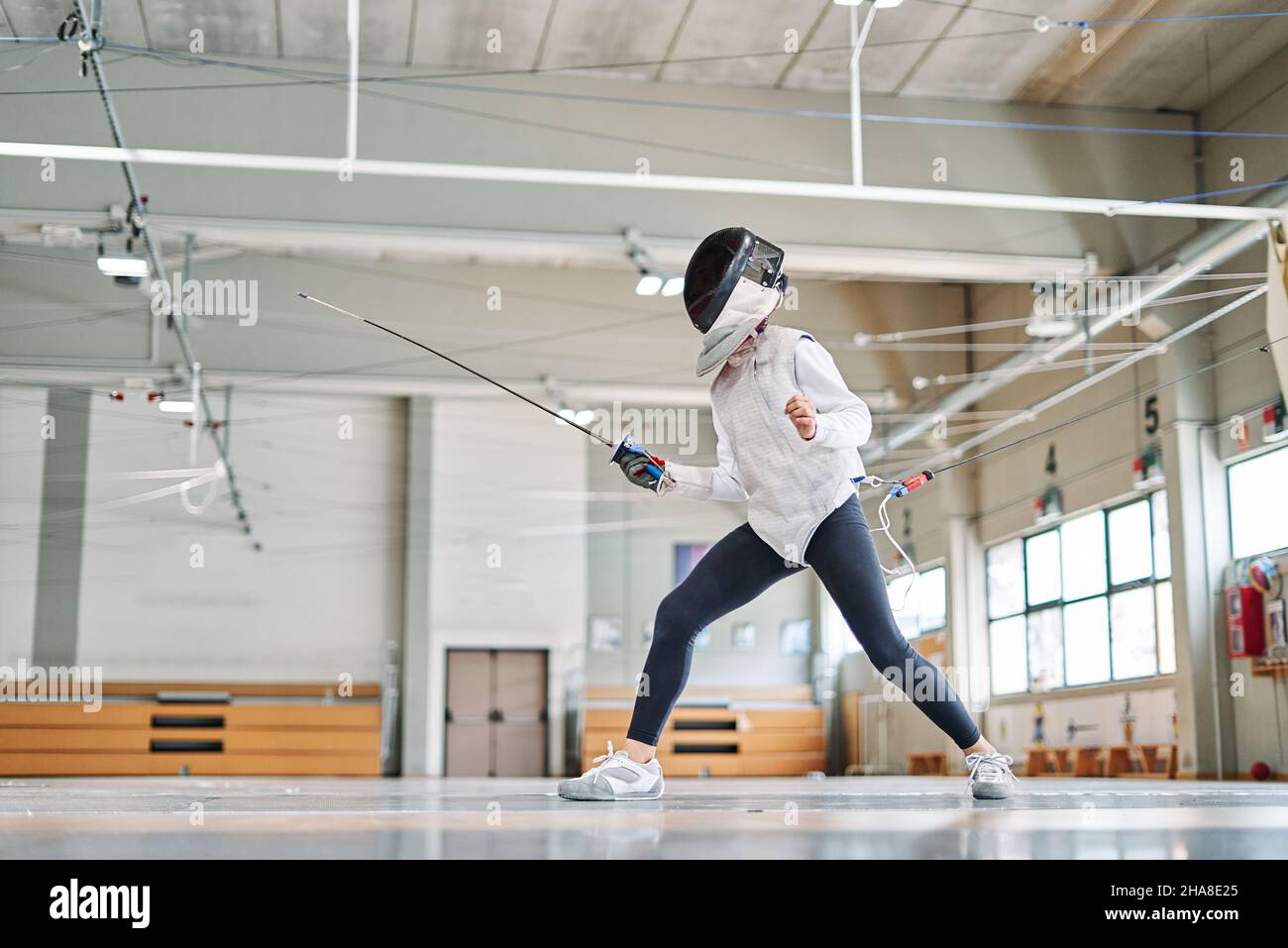 Fencing Training Roon Child practicing fencing inside the training room Stock Photo - Alamy