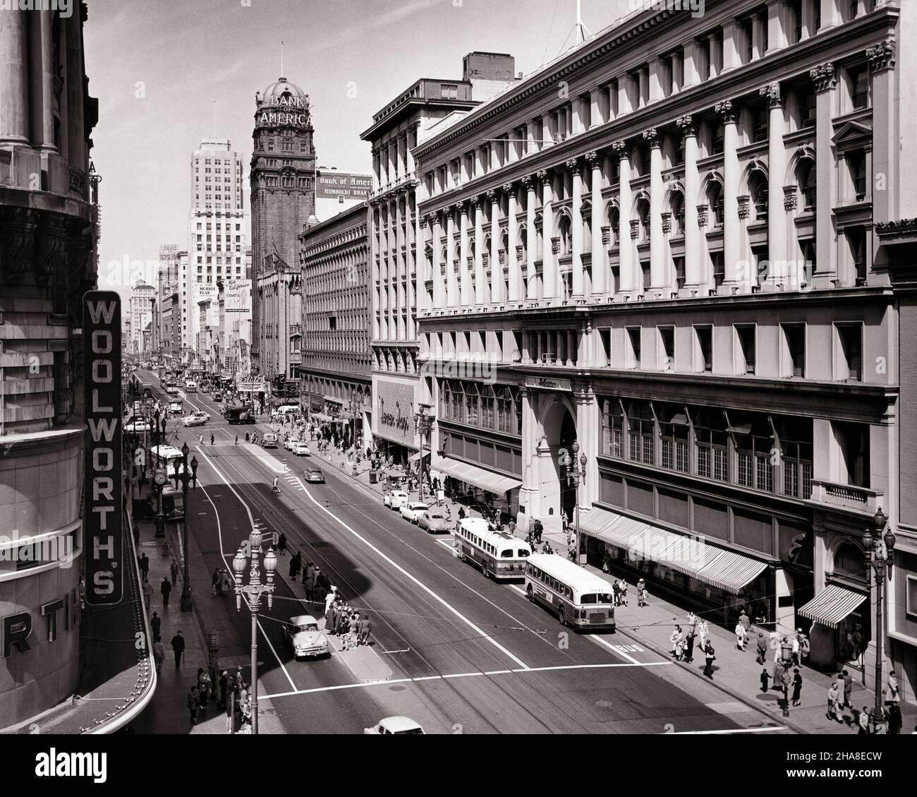 1950s SHOPS ALONG MARKET STREET AT POWELL STREET LOOKING EAST FROM THE EMPORIUM ACROSS FROM WOOLWORTH’S SAN FRANCISCO CA USA - r5541 FST001 HARS TRANSPORTATION B&W NORTH AMERICA SHOPPER NORTH AMERICAN SHOPPERS PEDESTRIAN STRUCTURE HIGH ANGLE ADVENTURE PROPERTY MOTOR VEHICLE AUTOS ALONG EXTERIOR CA STORES REAL ESTATE WEST COAST STRUCTURES ACROSS AUTOMOBILES CITIES VEHICLES EDIFICE SAN FRANCISCO BUSES COMMERCE POWELL TRANSIT WOOLWORTH'S BLACK AND WHITE BUSINESSES MOTOR VEHICLES OLD FASHIONED Stock Photo