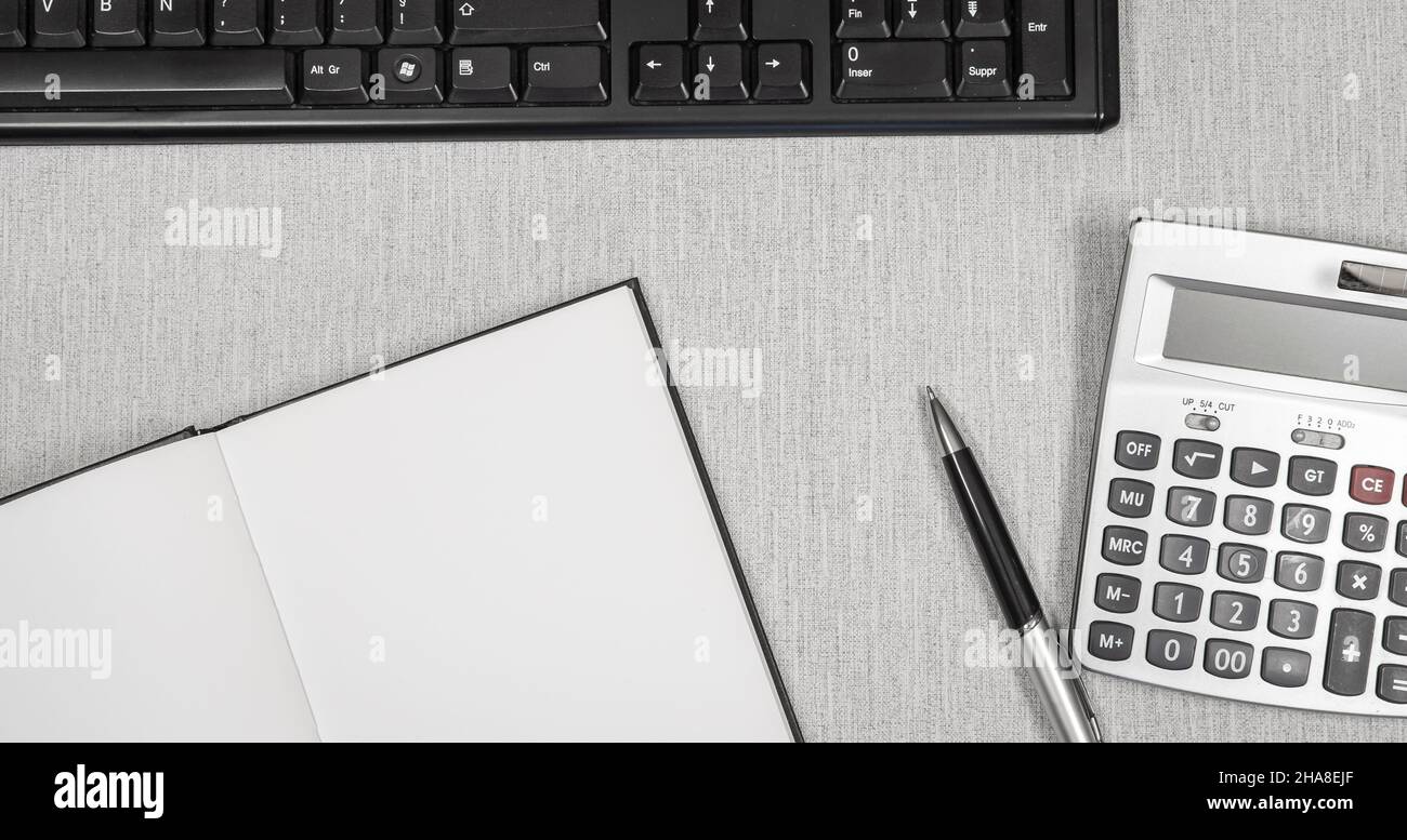 Book opened on a workspace. White pages for inscriptions. Stock Photo