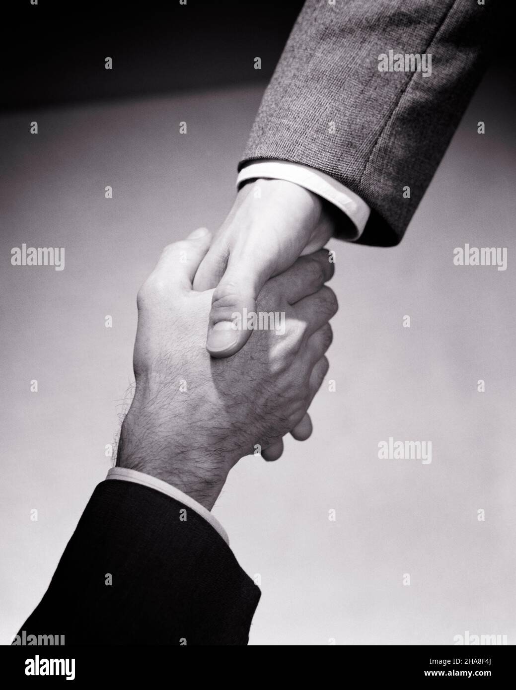 1950s 1960s HANDS ONLY OF TWO CAUCASIAN MEN SHAKING HANDS HANDSHAKE