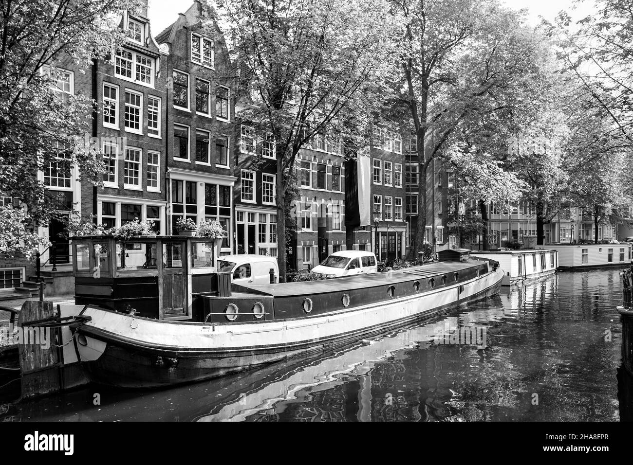 Canal in Amsterdam with houseboats. Black and white cityscape.  Netherlands Stock Photo