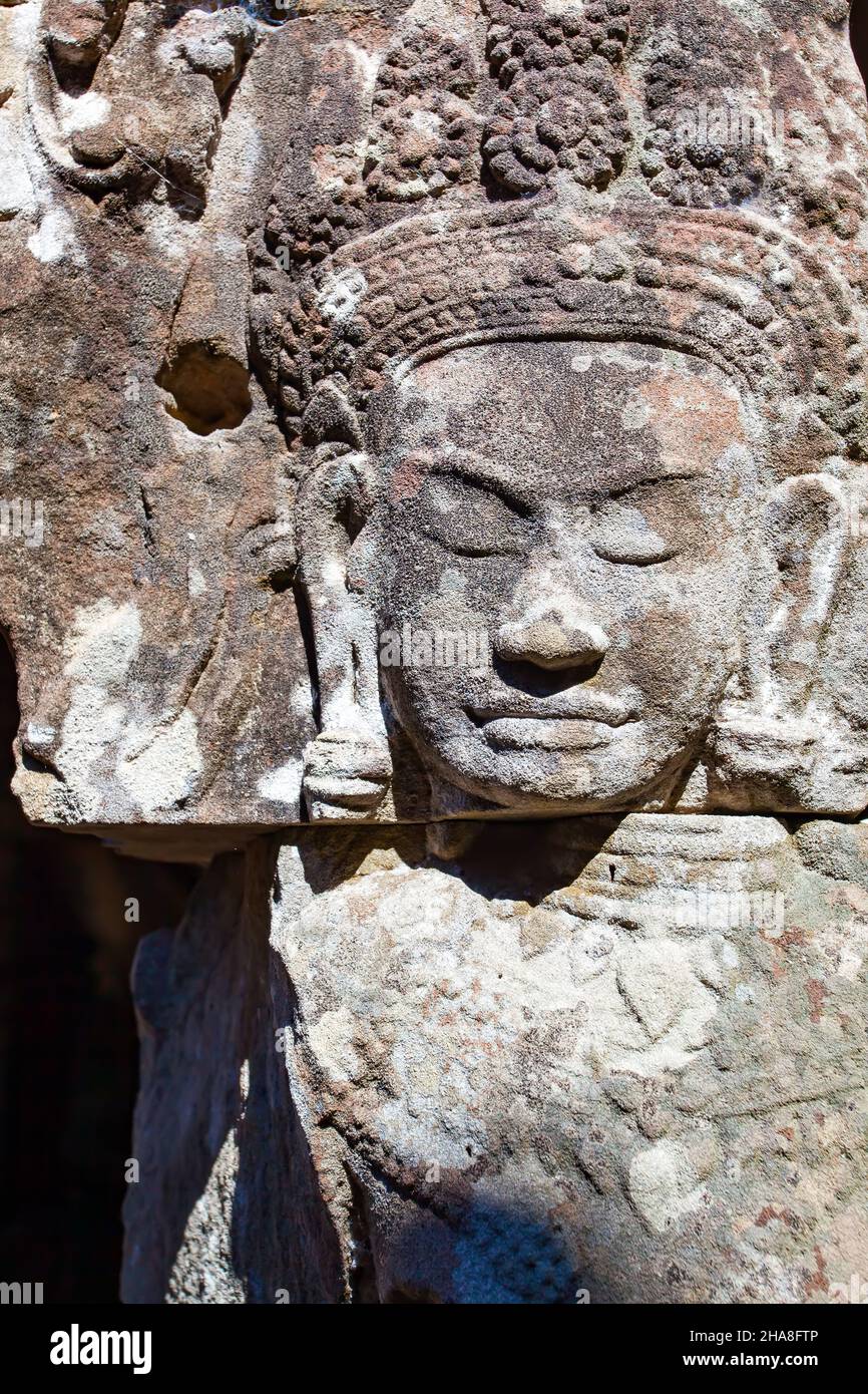 Face Ancient khmer stone carving in Angkor Wat, Cambodia Stock Photo