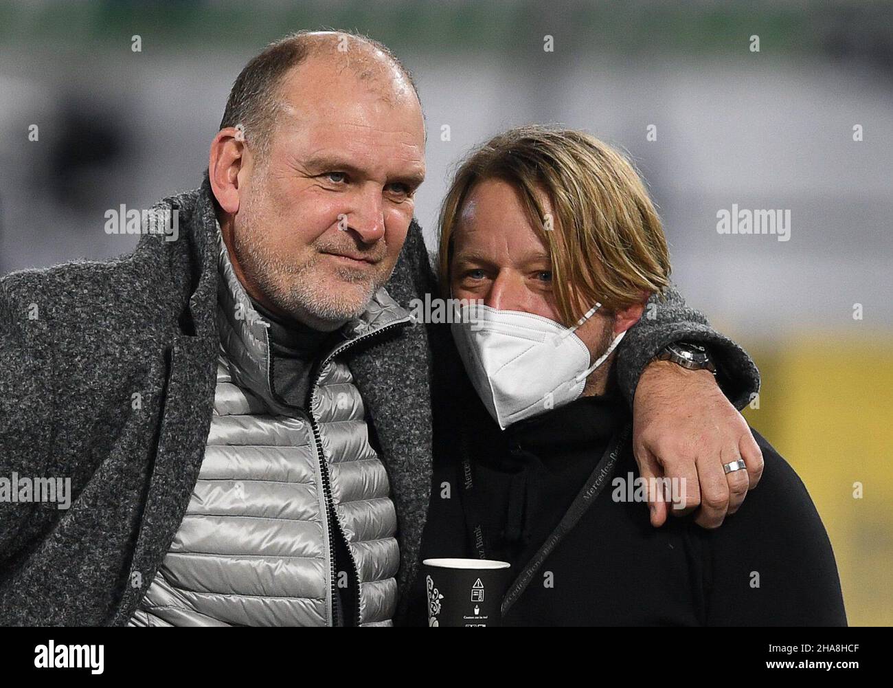 11 December 2021, Lower Saxony, Wolfsburg: Football: Bundesliga, VfL Wolfsburg - VfB Stuttgart, Matchday 15 at the Volkswagen Arena. Jörg Schmadtke (l), Managing Director Sport of VfL Wolfsburg, and Sven Mislintat, Sport Director of VfB Stuttgart, are in the stadium before the match. Photo: Swen Pförtner/dpa - IMPORTANT NOTE: In accordance with the regulations of the DFL Deutsche Fußball Liga and/or the DFB Deutscher Fußball-Bund, it is prohibited to use or have used photographs taken in the stadium and/or of the match in the form of sequence pictures and/or video-like photo series. Stock Photo