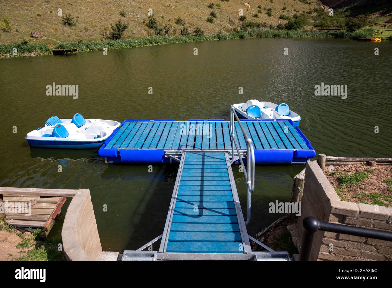 Two paddle boats connected to a floatable jeti on a lake Stock Photo