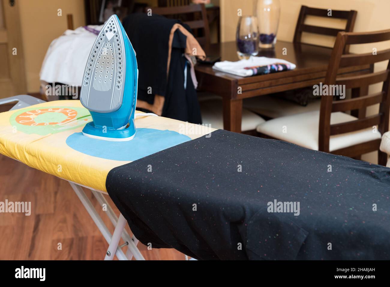 Funny ironing board, iron and black tshirt ready to be ironed, in the