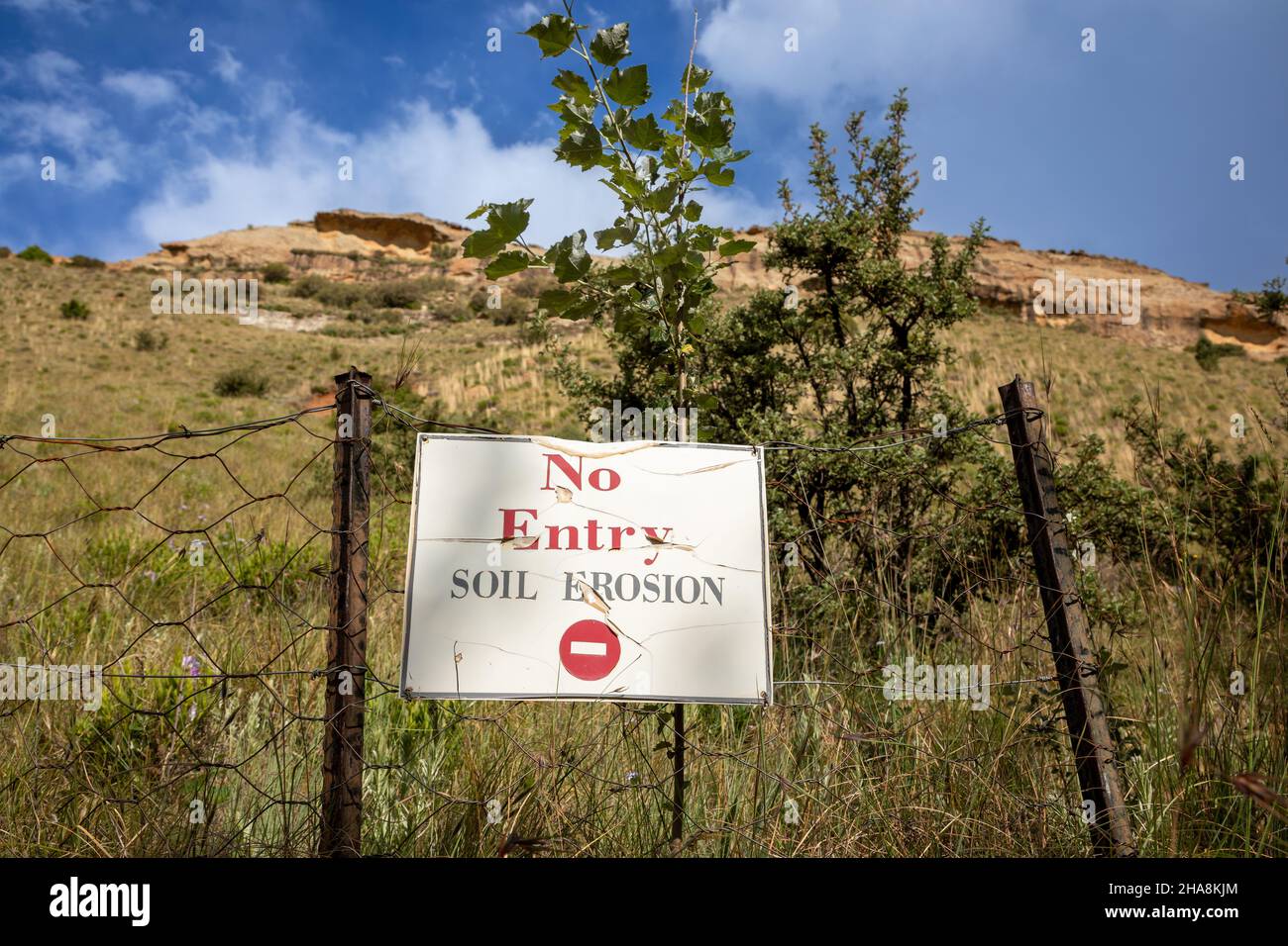Selective focus on a sign reading NO ENTRY Soil erosion with a mountain side behind it Stock Photo