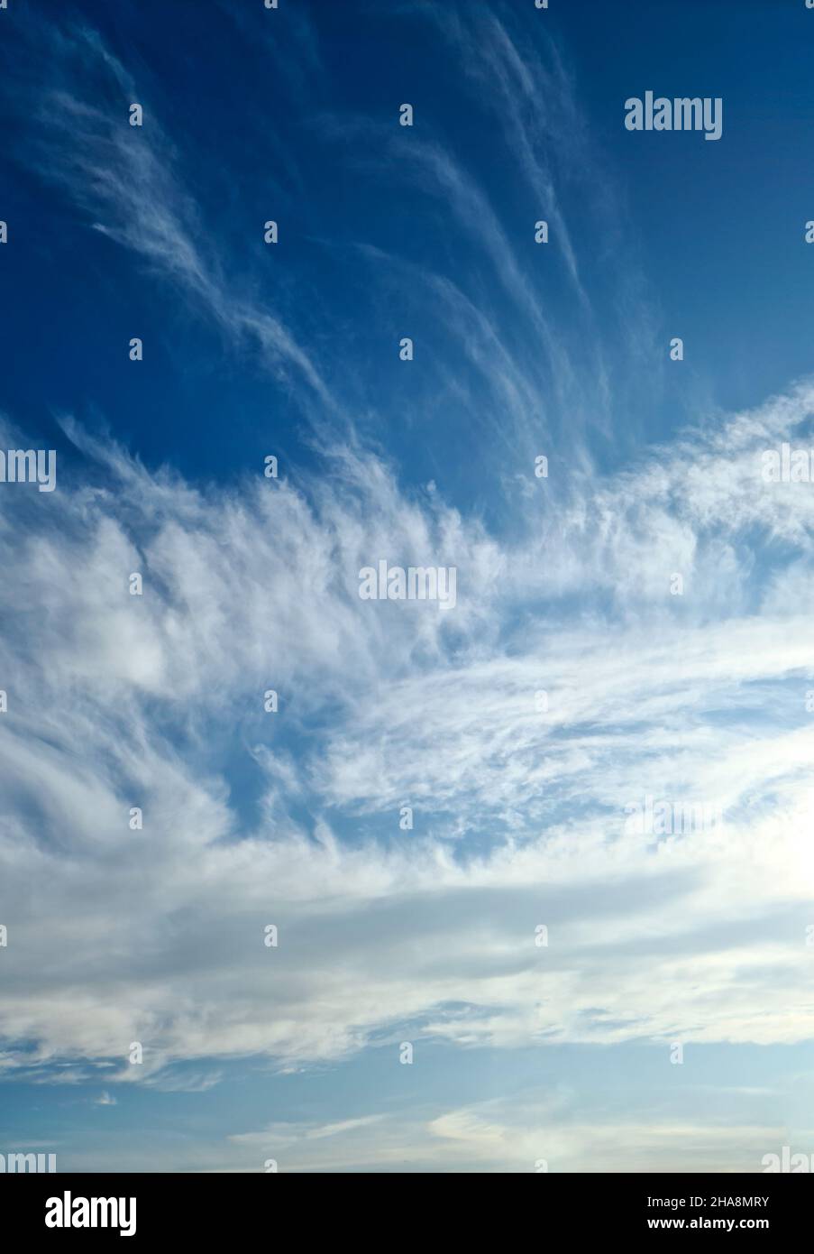 Stunning cirrus cloud formation panorama in a deep blue summer sky seen ...