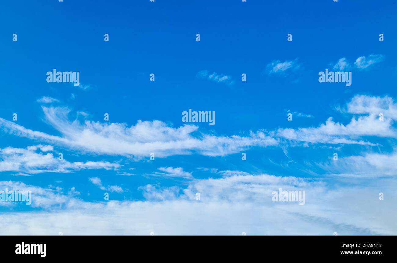 Stunning cirrus cloud formation panorama in a deep blue summer sky seen ...