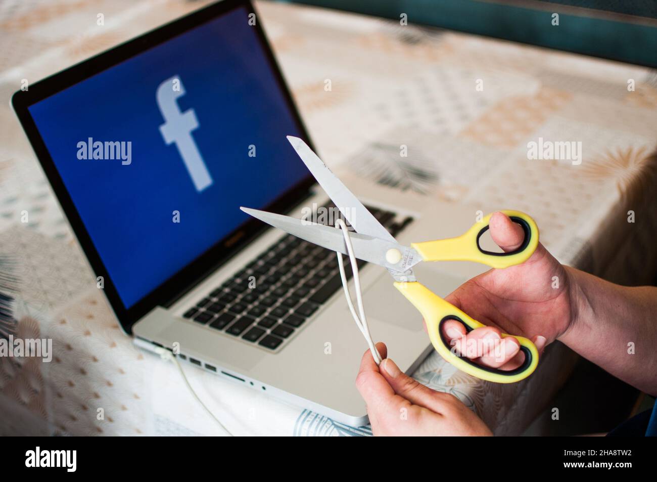 scissors cuts power to facebook Stock Photo