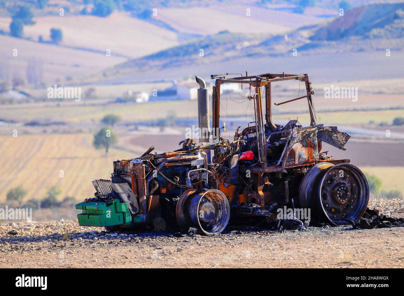 Tractor destroyed by fire in the middle of the field Stock Photo Alamy