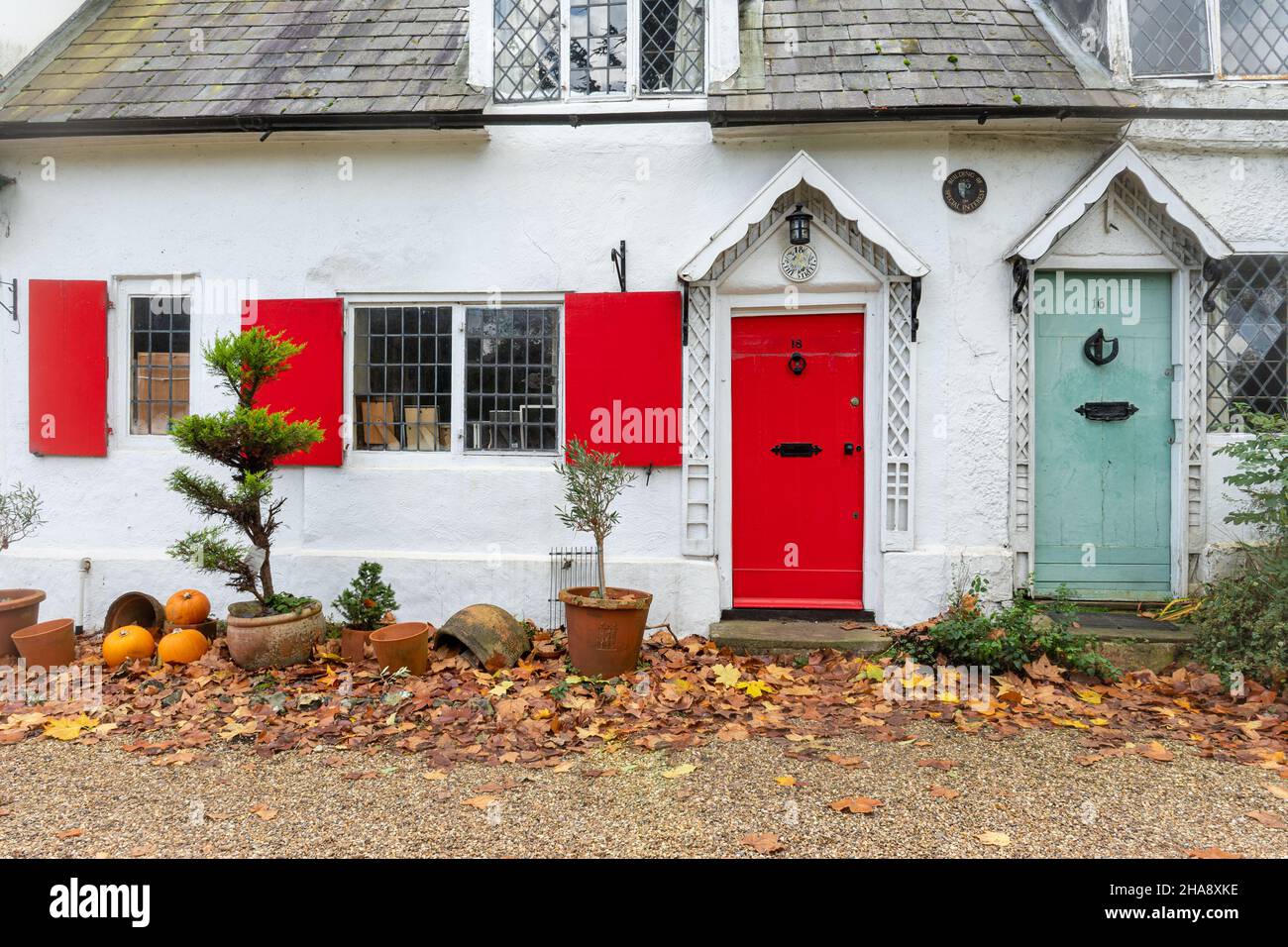 16 and 18, The Street, Shalford, Surrey, England, UK. Grade II Listed Building, 17th century cottages with colourful doors and shutters in the village Stock Photo