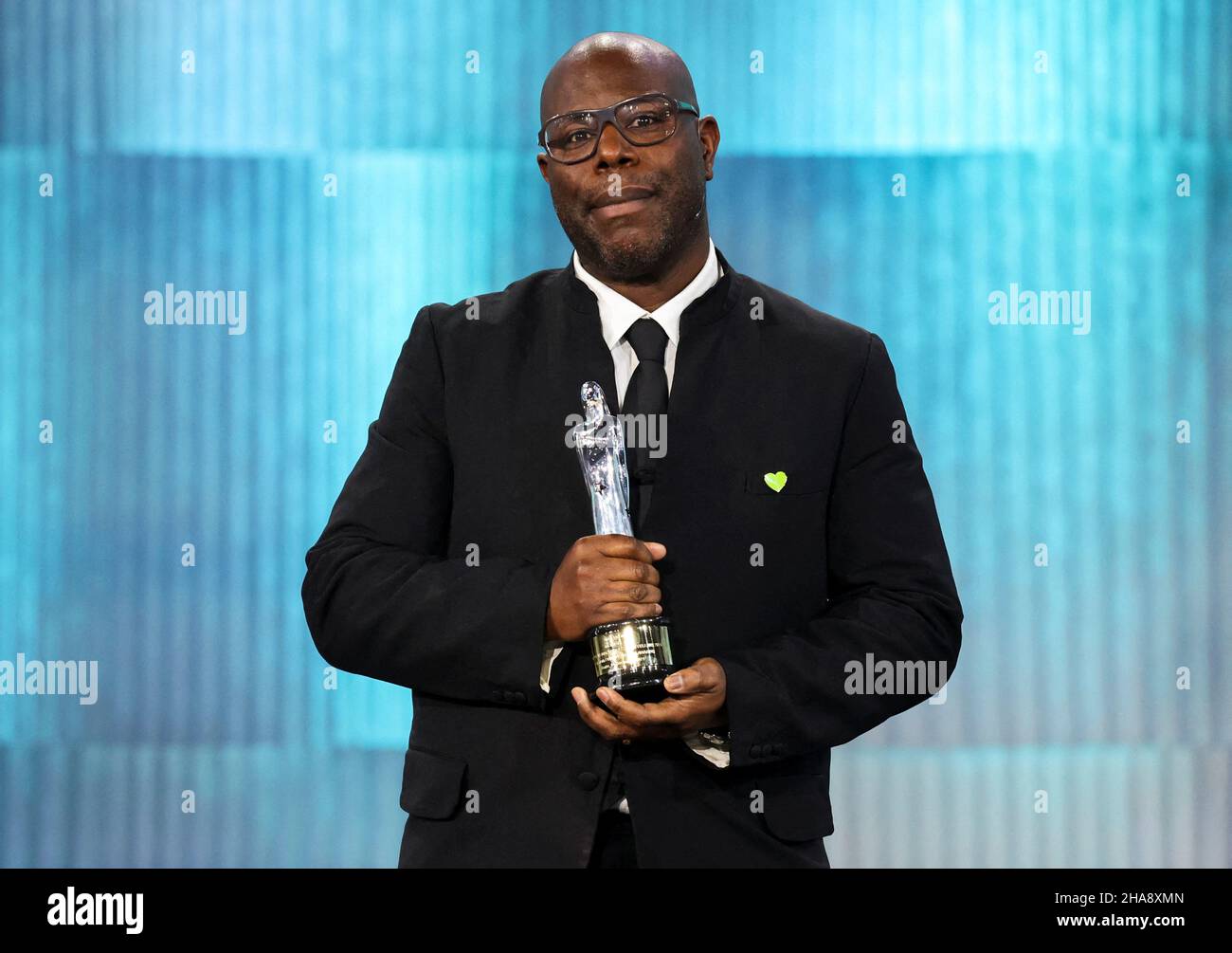 Berlin, Germany. 11th Dec, 2021. Steve McQueen (l) receives the award for innovative storytelling for 'Small Axe' at the 34th European Film Awards. The European Film Academy presents the awards in Berlin. Credit: Christian Mang/Reuters/Pool/dpa/Alamy Live News Stock Photo