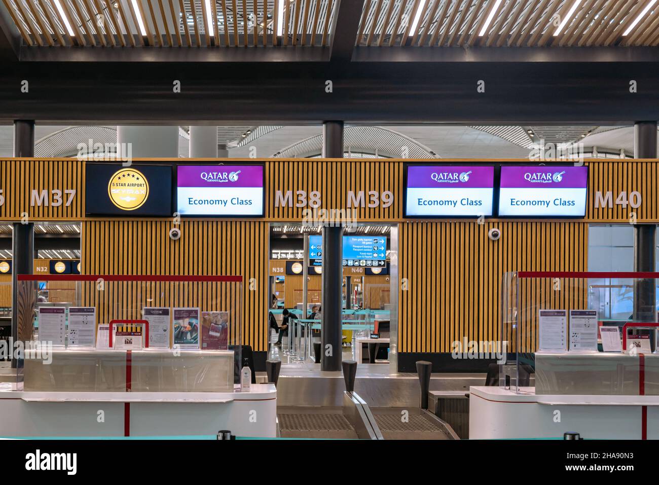 Istanbul, Turkey - November 2021: Qatar Airways check-in counter in Istanbul airport. Qatar Airways is one of the largest airlines in the Middle East. Stock Photo