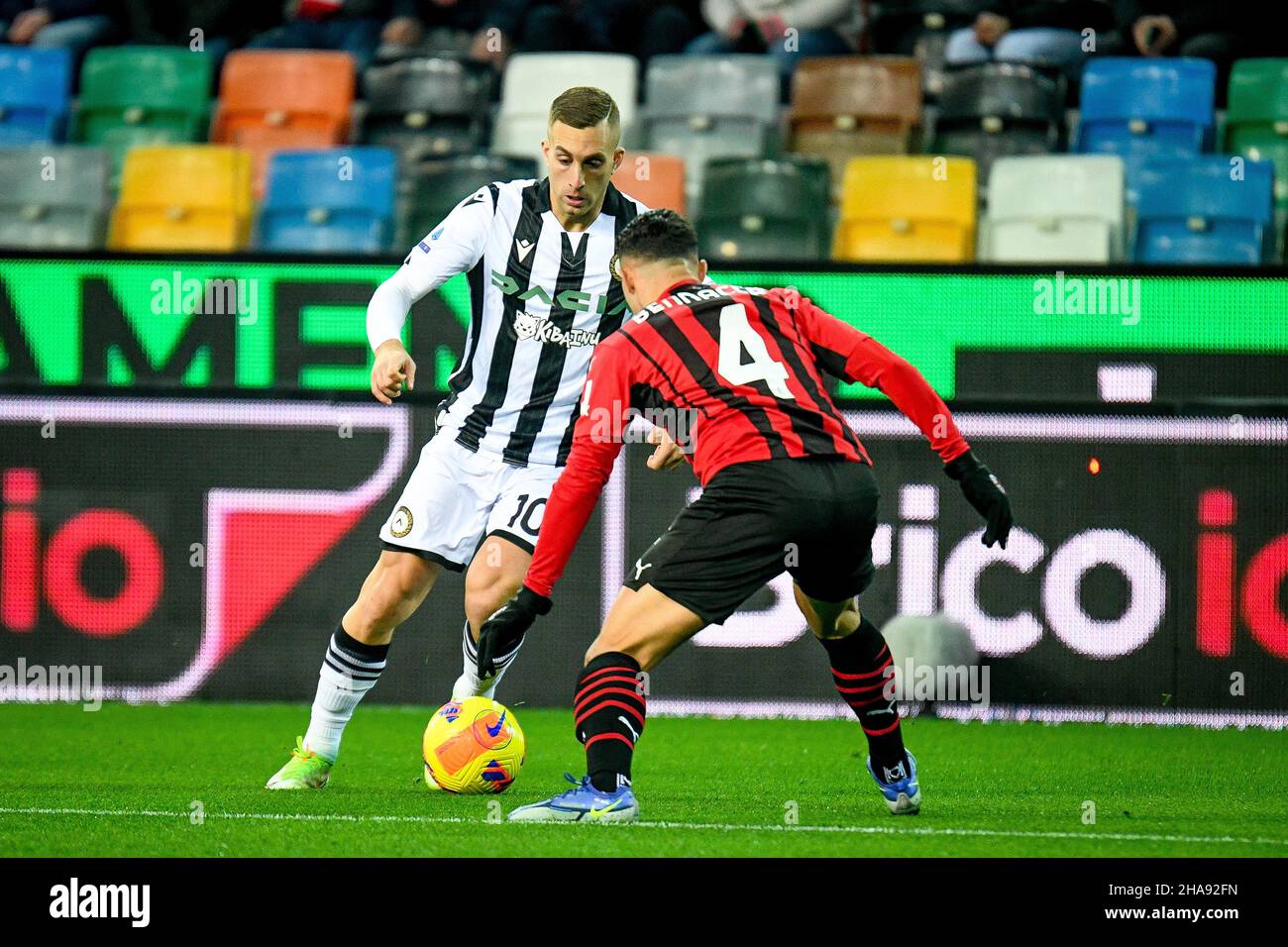 Udine, Italy. 11th Dec, 2021. Udinese's Gerard Deulofeu in action against  Milan's Ismael Bennacer (Milan) during Udinese Calcio vs AC Milan, italian  soccer Serie A match in Udine, Italy, December 11 2021
