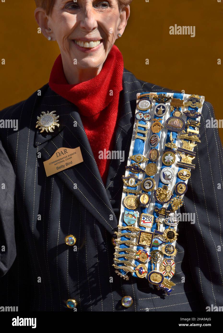 A member of the Daughters of the American Revolution wears her DAR pins