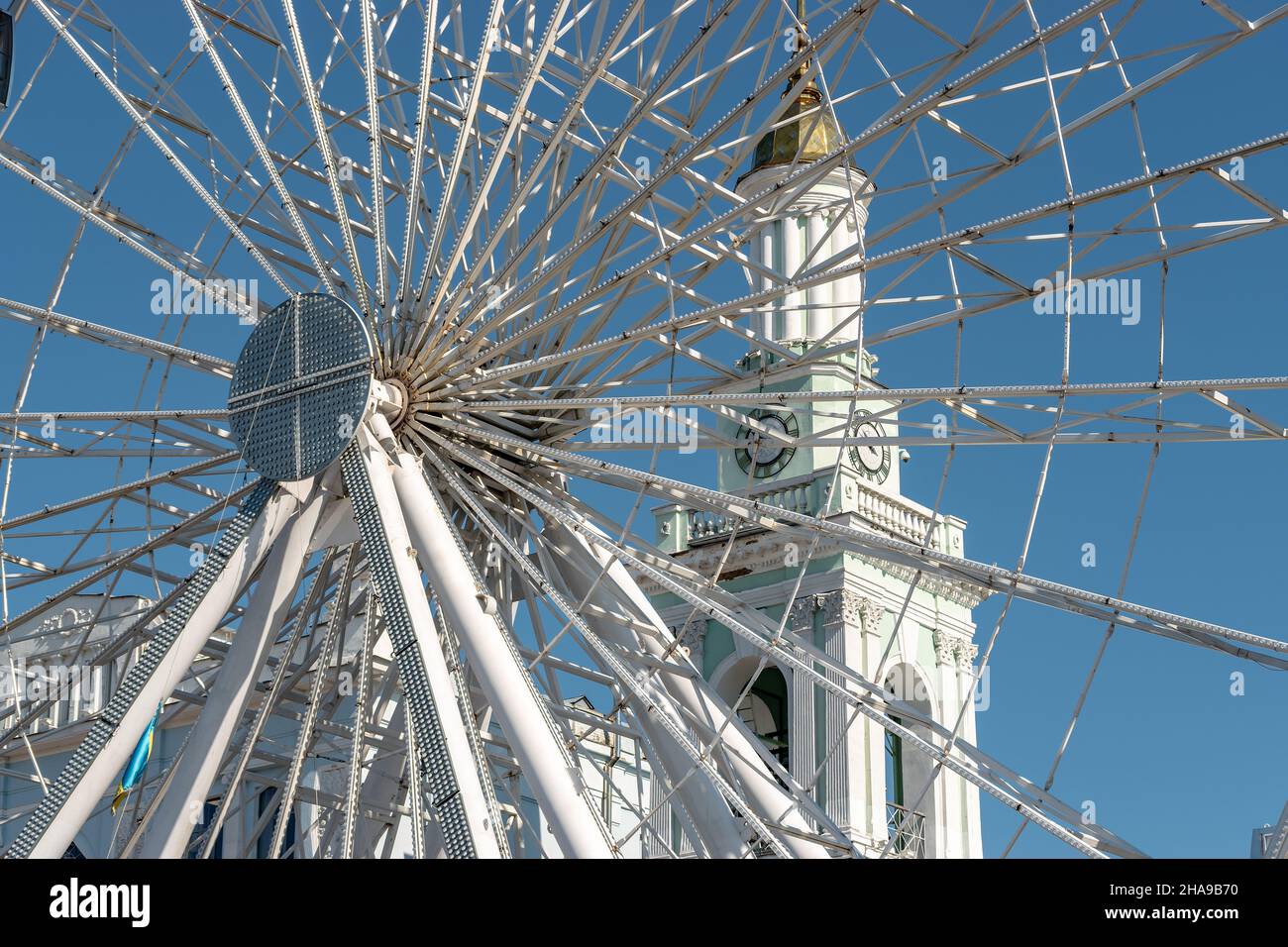 View of modern ferris wheel on background of blue sky in Kyiv city. Stock Photo