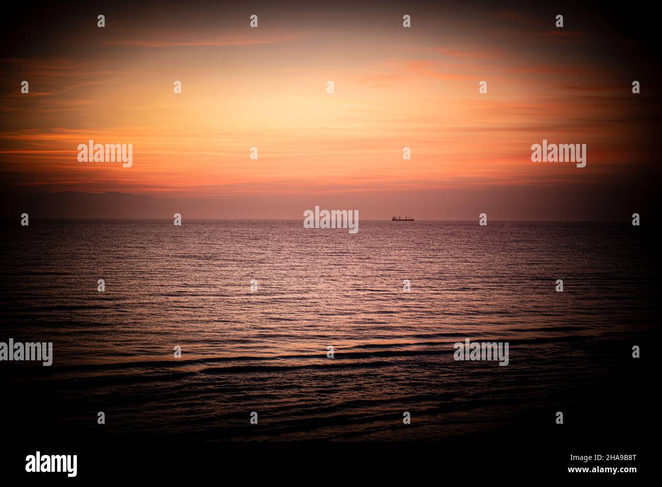 Beautiful view of the orange sunset over the calm sea Stock Photo - Alamy