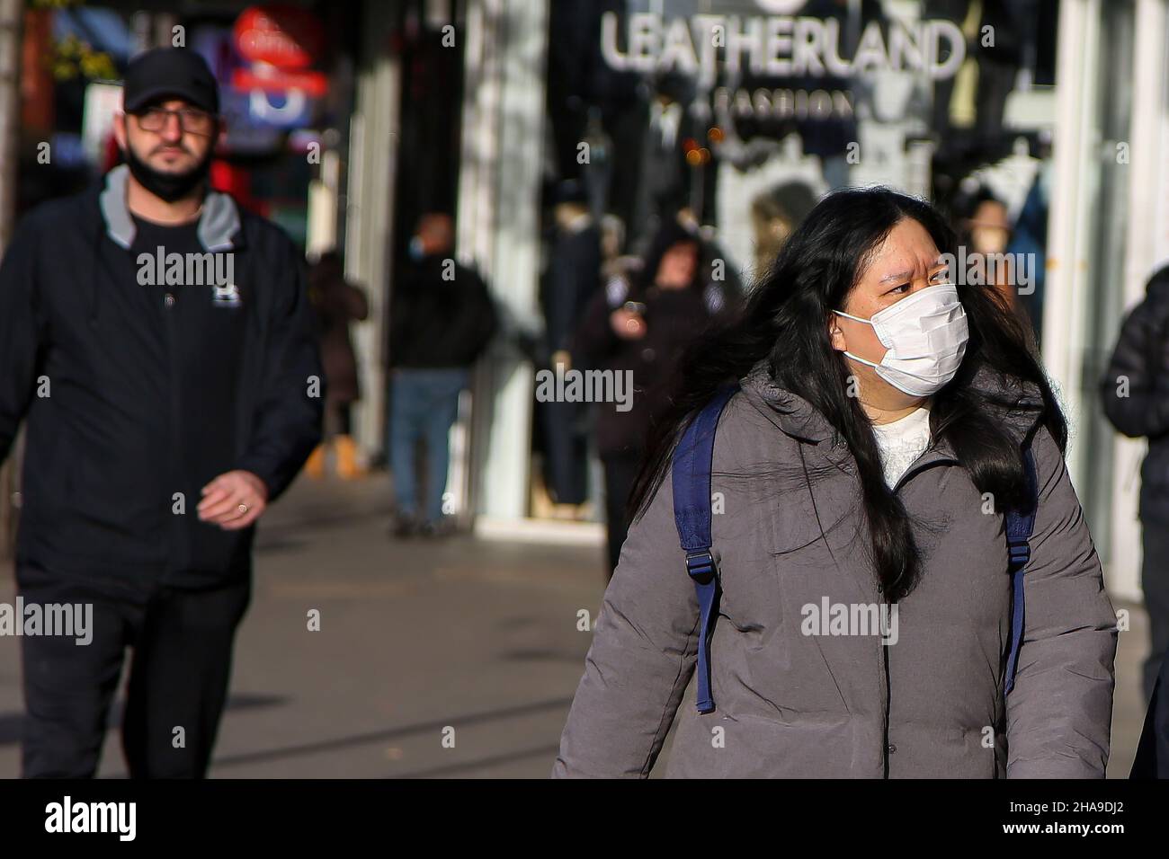 London, UK. 9th Dec, 2021. A woman wearing a face mask as a preventive measure against the spread of coronavirus walks on the street.Omicron variant continues to spread in the UK. The government has announced Plan B rules which includes compulsory wearing of face masks in more indoor places. (Credit Image: © Dinendra Haria/SOPA Images via ZUMA Press Wire) Stock Photo