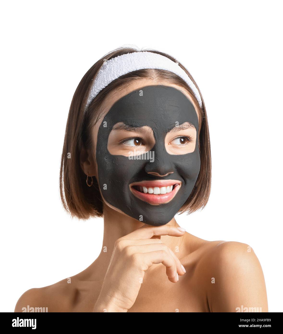 Young woman with activated charcoal mask on her face against white  background Stock Photo - Alamy
