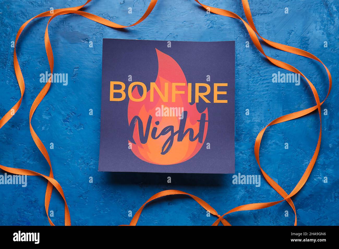 Greeting card for Guy Fawkes night and ribbon on color background Stock ...
